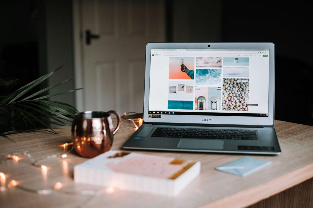 Computer on table surrounded by household objects